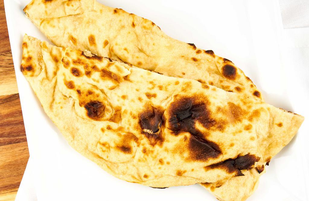 Naan · A white flour bread is baked in clay oven.