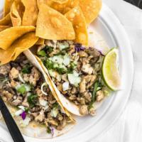 Jamaican Jerk Chicken Taco · Tropical seasoned seared chicken. Served with lime and tortilla chips. Choose corn, flour, o...