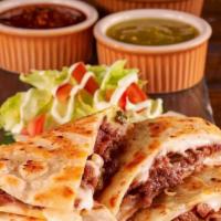 Quesadilla Con Carne · A large flour tortilla stuffed with cheese and choice of meat. Served with lettuce, tomatoes...