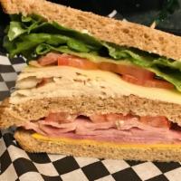 Cafe Club · Thinly sliced turkey and ham with bacon, cheddar and Swiss cheese garnished with lettuce and...