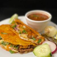 Taco Catrina · Shredded beef(birria)  cheese, onions and cilantro, sauce and consome.