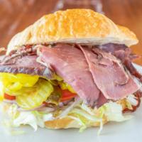 Pastrami Croissant Sandwich · Mayo, mustard, lettuce, tomato, onion pickles, banana peppers, and jalapeños.