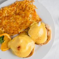 Eggs Benedict · Poached eggs on toasted English muffins with Canadian bacon, topped with hollandaise sauce.