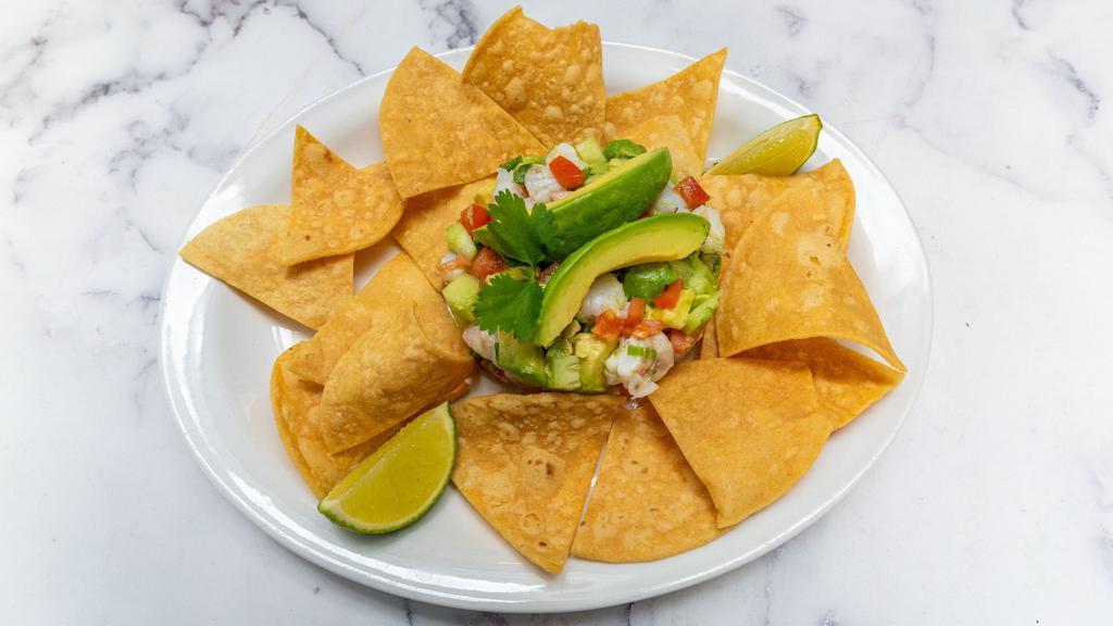 Ceviche Tower · Gluten-Free. Shrimp marinated in a fresh lime juice. Diced: Avocado, cucumber, tomato, jalapeños, and green onions. Served with housemade chips.