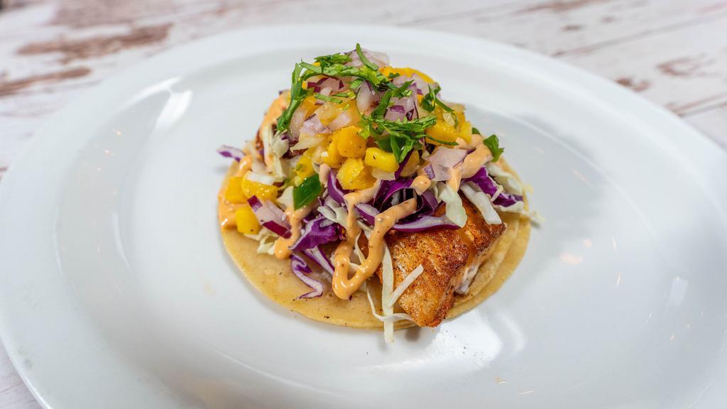 Mahi Mahi Single Taco · Gluten-Free. Topped with cabbage, Chipotle Crema, and Hot Honey Mango Salsa. Your choice of hand battered or charbroiled.