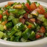 Shirazi Salad · Diced tomatoes, onion, cucumber, parsley, and mint mixed with olive oil and lemon juice.
