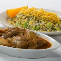 Lamb Shank · Seasoned baby spring lamb, cooked in a tomato base. Served with the special green rice of th...