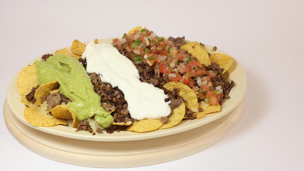Super Nachos · Chips, Cheese, Salsa, Guacamole, Sour Cream & your choice of Meat
