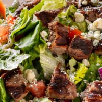 Bleu Cheese Steak Salad · Strips of CERTIFIED ANGUS BEEF steak, bleu cheese crumbles, diced tomato, and red onion on a...