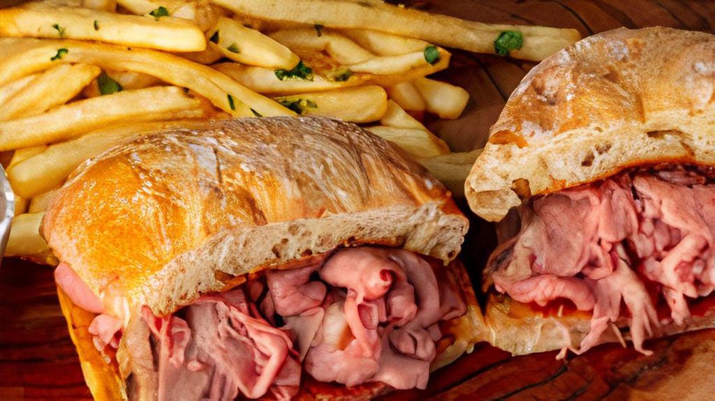 French Dip · Slow roasted Certified Angus Beef on a grilled Ciabatta roll. Served with au jus and your choice of side.