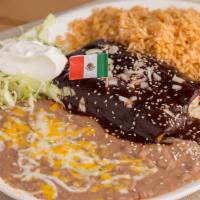 Mole Enchiladas · Two chicken enchiladas topped with mole sauce.