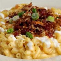 The Loaded Beast · Traditional mac & cheese, bacon, green onions, crème fraîche, fried shallots & roasted garli...