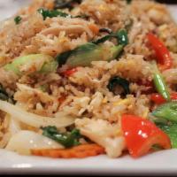 Basil Fried Rice · Jasmine rice stir fried with garlic, onions, scallions, bell pepper, eggs and basil.