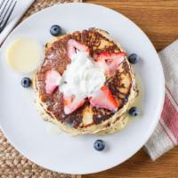 Tres Leches Pancakes · Buttermilk pancakes with fruits, tres leches sauce and whipped cream.
