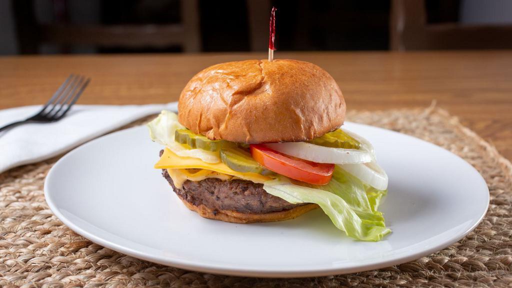 Cheeseburger  · Brioche bun, eight ounces Angus beef patty, American Cheese, lettuce, tomatoes, onions, pickles, and mayonnaise.