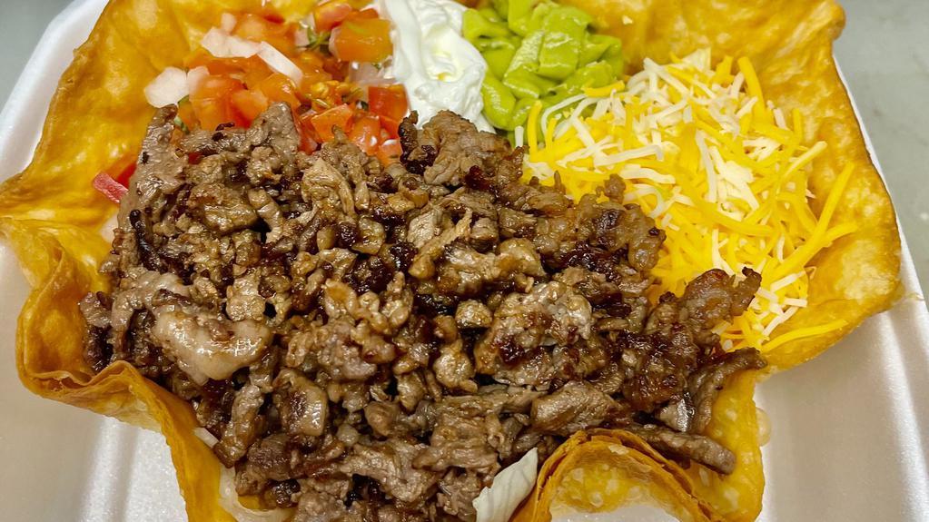 Tostada Salad · Fried Tostada shell served with beans, lettuce, cheese, pico de gallo, sour cream, guacamole and your choice of meat.
