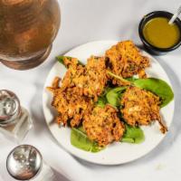 Vegetable Pakora · Deep fried onion, spinach, cabbage mixed in chickpeas flour batter. Served with mint chutney.
