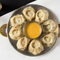#68. Chicken Momo (8 Pieces) · Steamed dumplings filled with minced chicken, onion, cilantro and spices. Served with Himala...