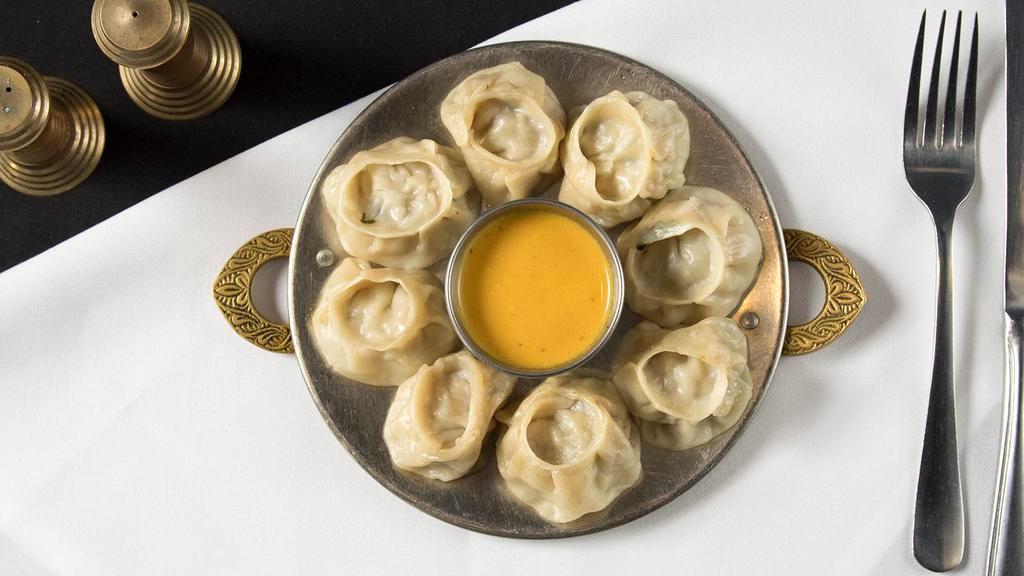 #68. Chicken Momo (8 Pieces) · Steamed dumplings filled with minced chicken, onion, cilantro and spices. Served with Himalayan sauce.