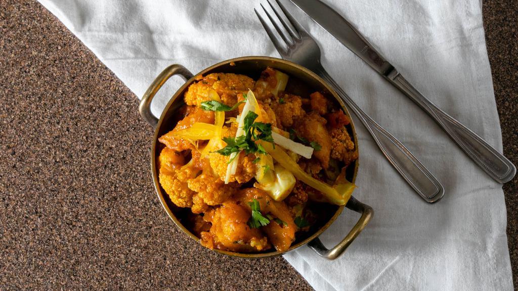 Aloo Gobi (Potato & Cauliflower) · Potatoes and cauliflower cooked with onion and tomato sauce with Himalayan herbs and spices.