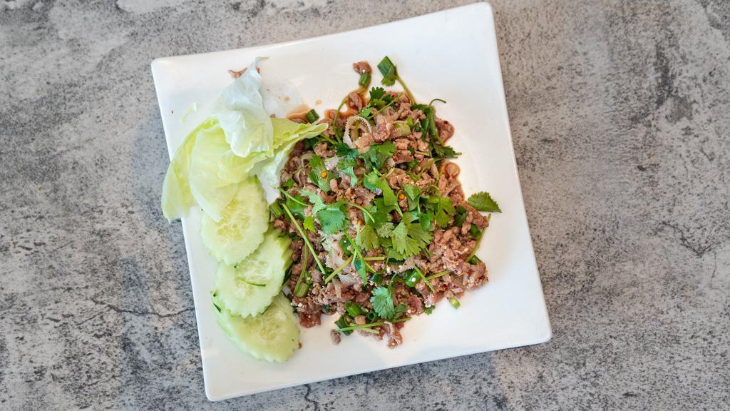 Beef Larb · Ground beef with book tripe (optional) mixed with green onion, cilantro, rice powder, ground Thai dried peppers, and lime juice. Served with lettuce and slice cucumber.