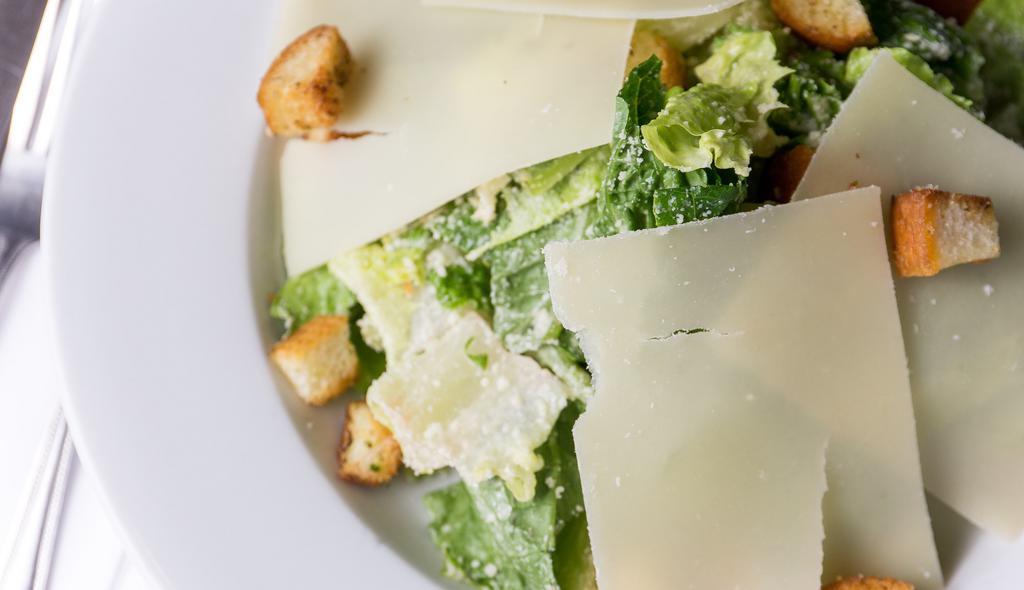 Cesare Insalate · Caesar salad with romaine, shaved grana padano Parmesan and rosemary croutons.