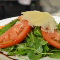Arugula Salad · Baby arugula, shaved Grana Padano Parmesan, extra virgin olive oil and balsamic vinegar.