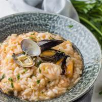 Risotto Di Pesce · Served with clams, mussels, calamari, and shrimp, with a light tomato sauce.