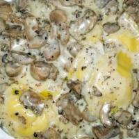 Truffle Ravioli · Black truffle’ & mushroom cream sauce, mushroom-filled ravioli, ‘white truffle’ oil.