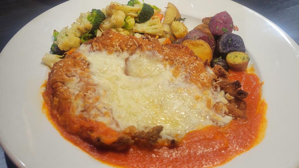 Chicken Parmigiana · Breaded chicken breast topped with mozzarella, tomato sauce and grated parmesan.