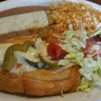 Chile Relleno · Ortega chile filled with melted cheese. includes a soup salad rice and beans.