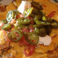 Nachos · A 524 favorite. Topped with guacamole, sour cream, tomatoes and jalapeños.