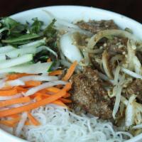 Bun Bo (Thit) Xao · Meat stir-fried with lemongrass over rice vermicelli noodles. Topped with scallion oil, fres...