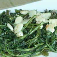 Rau Muon Xao Toi · Water spinach stir-fried with garlic.