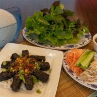 Bo Nuong La Lot · Grilled beef rolled in wild betel leaves. Served on a bed of rice vermicelli and special dip...