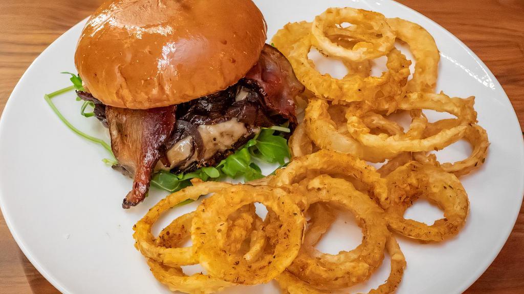 Caramelized Onion Burger · Hand crafted angus beef patty, with crispy bacon caramelized onion, Swiss cheese and lettuce on fresh brioche bun with housemade sauce.