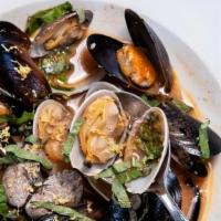 Steam Mussels · Fresh Mussels in a butter garlic lemon sauce topped with basil and lemon zest. Served with F...