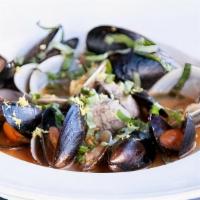Steam Clams · Fresh Clams in a butter garlic lemon sauce topped with basil and lemon zest. Served with Fre...