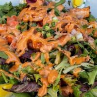 Shrimp Louie Salad · A bed of crispy lettuce topped with Cajun- spiced shrimp, red onions, diced tomatoes, and ha...