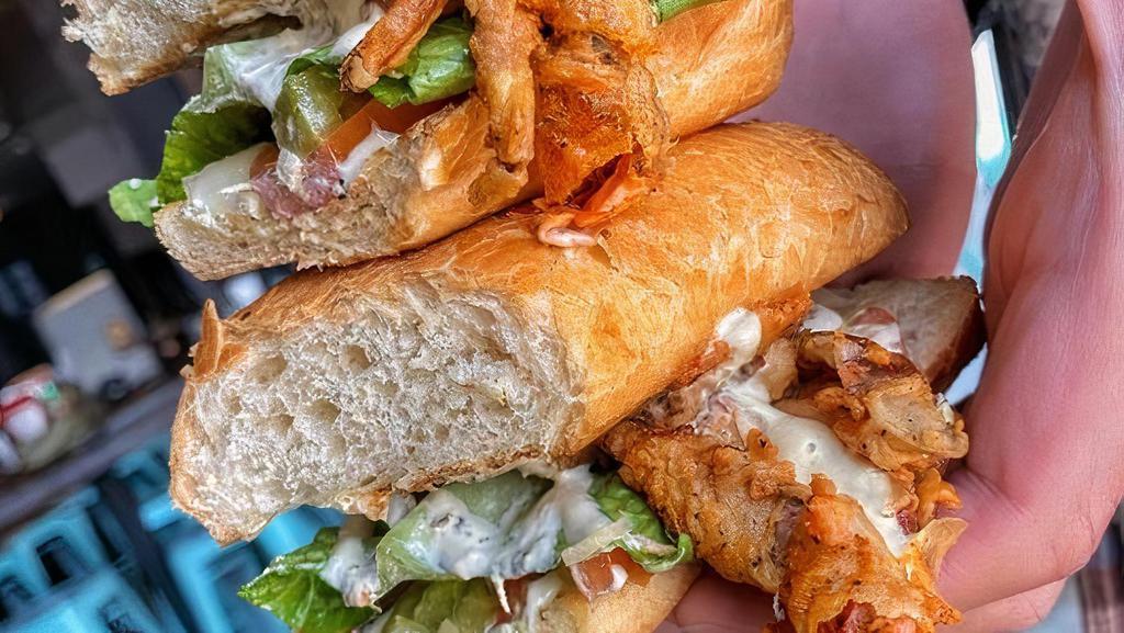 Softshell Po Boy · Soft Shell Crab in a toasted French roll with real Mustard and Remoulade spread. Crisp lettuce, tomato, sautéed celery, onion, and green bell peppers, and your choice of Cajun fries, regular fries, and House salad.