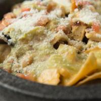 Nachos Del Rey · Grilled chicken nacho cheese, black beans, pico de gallo crema, aguacatillo, cotija cheese.