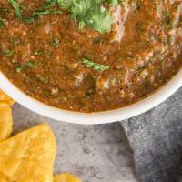 The Salsa · Fire-roasted tomato, onion cilantro garlic chipotle.