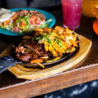 Sizzling Combo Fajitas · Sizzling hot Seasoned Asada Steak, Chicken Breast and Jumbo Shrimp, Bell Peppers and Onions ...