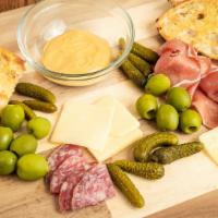 Charcuterie · Cured meats and cheeses, cornichons, mustard, grilled bread.
