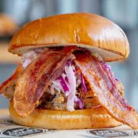 Specialty Smoked Pulled Pork · Pulled pork smothered in our tangy BBQ sauce, with smoked bacon, pickles and coleslaw on a b...