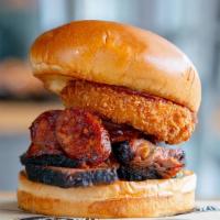 Specialty Smoked Brisket · Smoked brisket with spicy smoked Texas hot links, a crispy onion ring, our spicy BBQ sauce a...