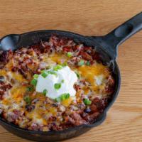 Brisket Chili · Cooked with brisket, onions, peppers, red, white and black beans.  Topped with cheddar chees...