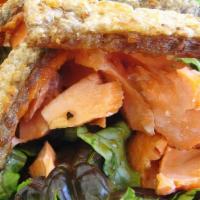 Salmon Skin Salad · Salmon skin, mixed greens, pickled carrots, seaweed salad, bonito flakes & sakana sauce.