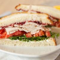 Roasted Turkey · Oven roasted turkey breast, tomatoes, arugula, cranberry jam and herbed cream cheese on brio...
