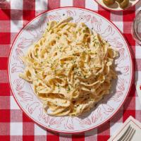 Fettuccine Alfredo · Fettuccine pasta tossed in a creamy alfredo sauce.